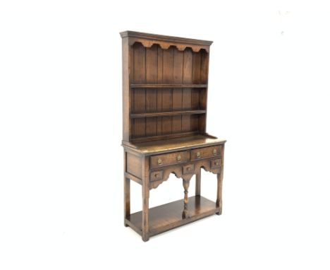 Small 17th century style oak dresser with plate rack, two drawers and three small spice drawers, turned middle support with u