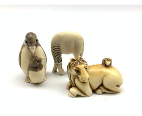 Japanese ivory netsuke in the form of a horse and rabbit, signature mark to base, another in the form of a penguin and chick 