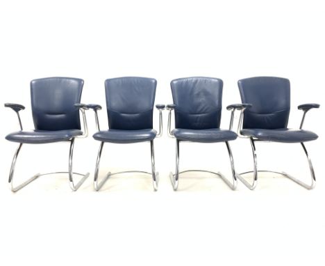 Set four vintage mid 20th century arm chairs, with seat and back panel upholstered in blue leather, raised on swept chrome su