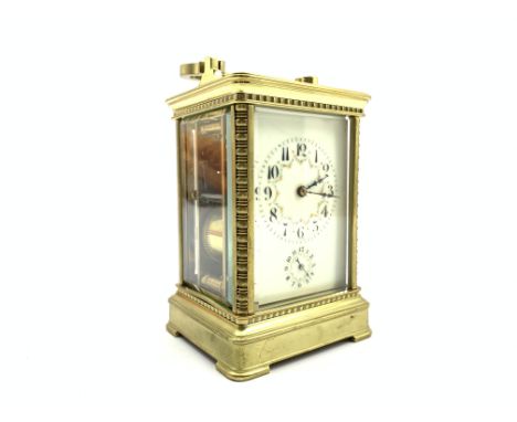 Late 19th Century carriage clock with repeat movement and alarm, floral decorated white dial in brass and bevelled glass case