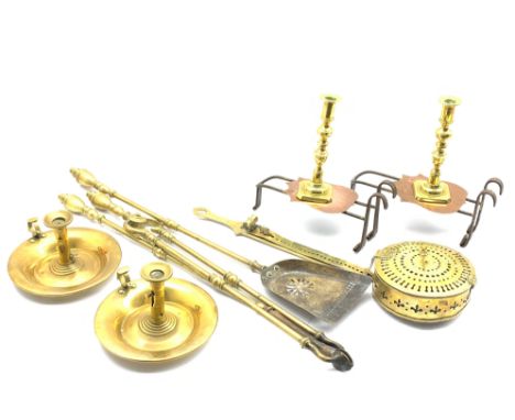 Pair of brass candlesticks, two brass chambersticks with side ejectors, pair of Victorian trivets, brass fireside tools and o