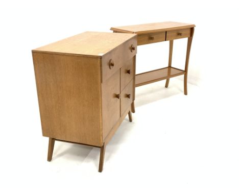 Mid century G-Plan design light oak chest, with one long drawer, two deep drawers and cupboard enclosing shelf, raised on spl