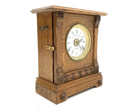 Early 20th century automatic alarm oak cased mantle clock, eight day movement striking hammer on gong and bell, white enamel 