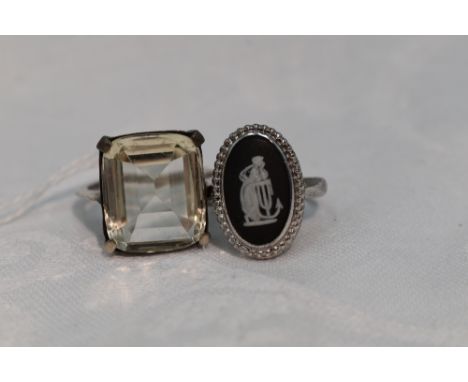 A lady's dress ring having an oversized paste stone to four claw collared mount to white metal loop, no marks tested as silve