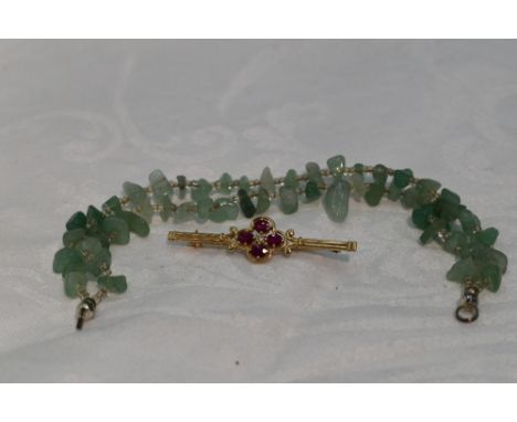 A 9ct gold bar brooch having ruby and diamond chip decoration and a Jade style bracelet (AF)
