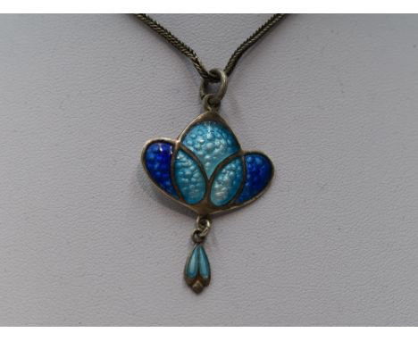 An Edwardian silver and enamel Art Nouveau pendant in shades of blue, Birmingham 1908, James Fenton on a white metal chain wi