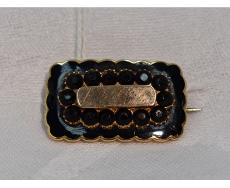 A Victorian mourning brooch of rectangular form having black enamel decoration to yellow metal mount and inscription to rever