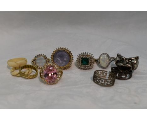 A selection of fashion rings of various designs including cherub, moonface, faux opal etc, some stamped 925