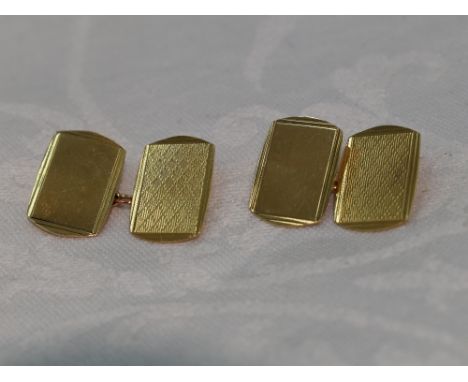 A pair of 9ct gold cufflinks having engine turned decoration, plain panels and chain connecters.&nbsp; approx 5.4g