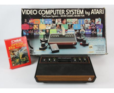 Atari CX-2600 Video Game System with boxed game Combat and 2 sets of controllersCondition Report:  Item is boxed and complete