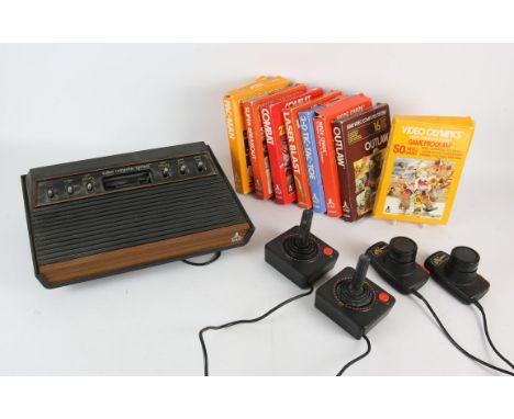 ATARI 2600 console with accessories and 8 games Accessories include: paddle x2 and classic joystick x2 Games include: Pac-Man