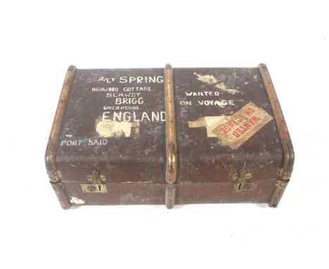 A 20th century vintage travelling trunk belonging to Lieutenant Spring. With wooden supports, the exterior covered with stick