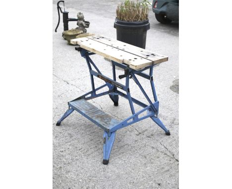 A Black & Decker Workmate folding work bench. Mounted on a blue metal stand, H76.5cm x W87cm x D74cm