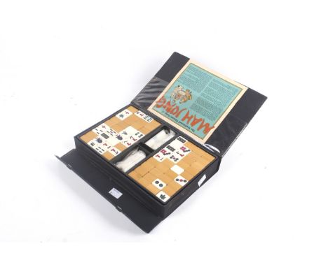 A vintage Mahjong set. Complete, with wooden and plastic counters and sticks, within a fitted box with the original instructi