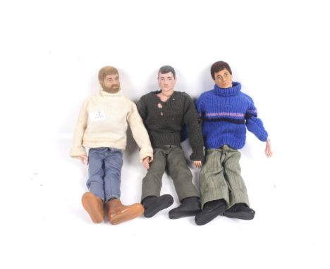 Three Palitoy Action Man figures. One with a beard and facial hair, some dressed in the original clothing, all marked 'Palito