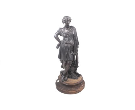 A cast metal model of Ceres, the goddess of corn. Standing proudly with a hand on her hip, mounted on a circular wooden base,