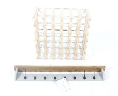 A contemporary wine rack and a wall handing coat rack with shelf. The wine rack is designed for forty-two bottles, the metal 