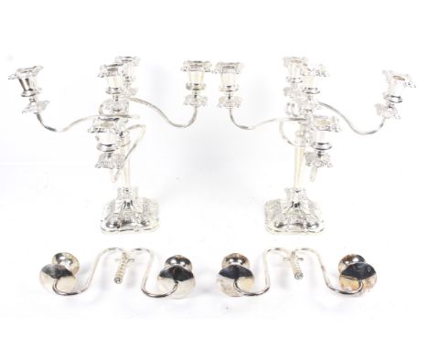 A pair of silver-plated four-branch/five-light candelabra. With shaped-square floral nozzles and bases, H33cm