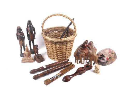 An assortment of 19th century and later treen. Including a Rutters horse twitch, carved tribal figures, painted masks, a carv