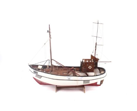 A 20th century handmade wooden model of a fishing trawler. With a red and white painted hull marked 'E714'. H45cm