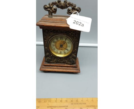 Fantastic Quality  little Brass and Wood  Carriage Clock Ornate Brass  Front with Dragon pattern on 4 Ball Feet winds Ticks a