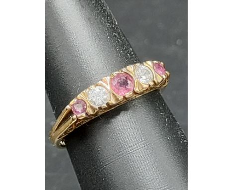 9ct gold ring set with ruby and clear stones . 