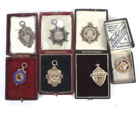 A collection of seven silver fob medals. To include one with enamel decoration 'Loughborough Whist League', approximately 84g