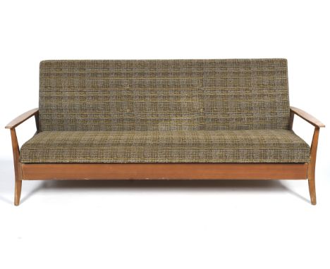 A mid-century sofa bed. With tapered, slightly curved arms and raised on curved legs, with yellow and green textured upholste