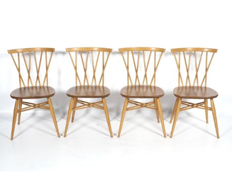 Four Ercol beech and elm candlestick dining chairs. Each on tapering legs joined by X-cross stretchers, with labels, 79.5cm h