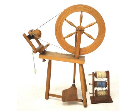 A vintage beech spinning wheel and bobbin holder with three bobbins. Height of spinning wheel 89cm