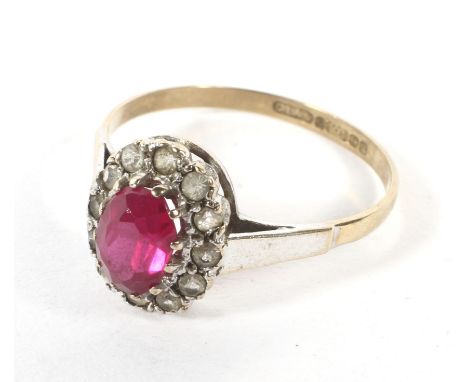 A 9ct gold ruby and diamond dress ring. The central ruby surrounded by 12 diamonds, size S, weight 1.9 grams.