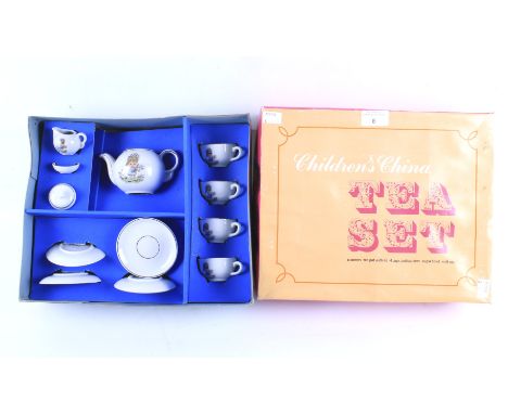 A vintage child's Continental porcelain tea set. Comprising: a teapot, tea cups, saucers and milk jug, in original box