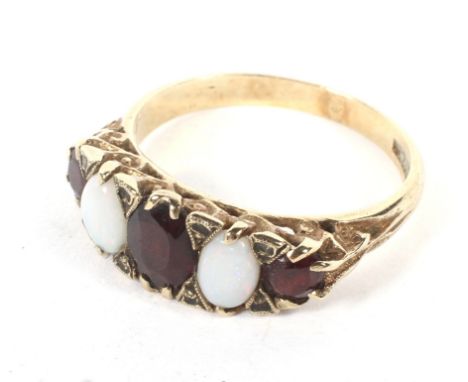 A 9ct gold opal and garnet dress ring. Set in a Victorian style mount, size R, weight 3.5 grams