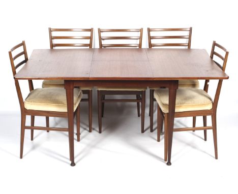 A 1960s teak extending dining table and five Meredew dining chairs. The tapering rectangular topped dining table with extra l