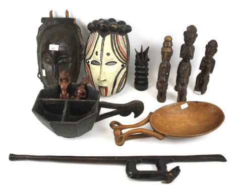 An assortment of mostly African tribal carved wood items. Including a sectioned bowl with hooked handle, various figures, an 