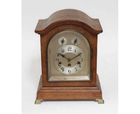 An oak cased domed top mantle clock, movement striking on single coil, height 37cm.  