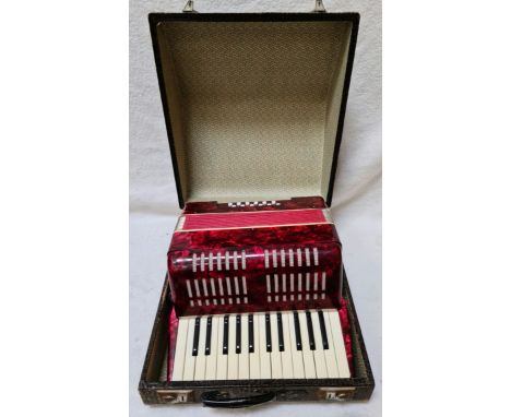 A German piano accordion in hard case.  