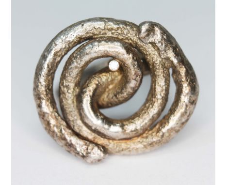 A modern cast silver ring form from a continuous swirl and set with a small diamond, sponsor's mark 'LB', London, gross wt. 1
