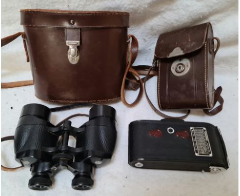 A vintage Voigtlander Bessa camera and a pair of Ross Solaross binoculars, both with cases.  