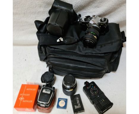 A camera bag with Pentax ME Super, various lenses and accessories.  