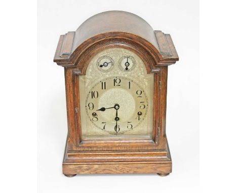 A domed oak mantle clock, steel dial, striking movement, height 37cm.Condition:- Not tested, sold with no guarantee.