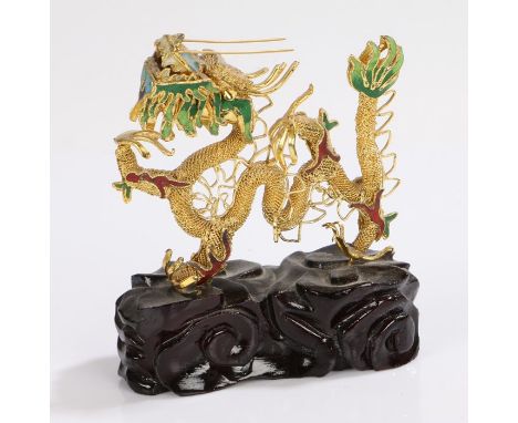 Chinese gilt metal and enamel dragon, modelled standing on an ebonised base, 13.5cm high