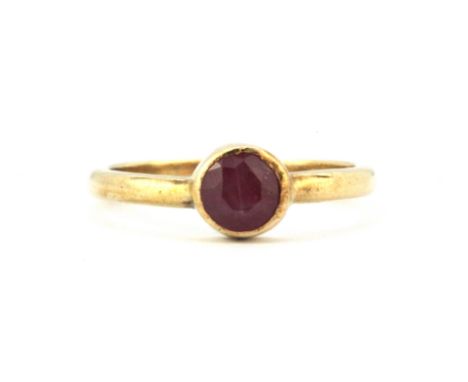 A 9ct yellow gold ruby set solitaire ring, (L).