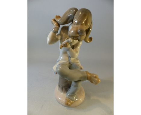 Lladro -  a comical dog sat upon a seat singing