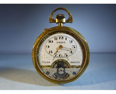 Amida Facon 8 day open faced Brass pocket watch, the silvered dial with Arabic numerals, visible escapement, engine turned ca