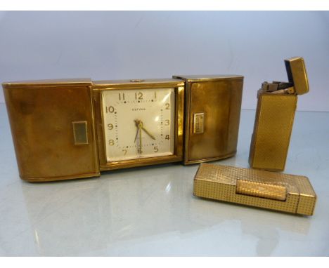 Vintage brass Estyma Jewels travel clock in retractable case and two Dunhill lighters