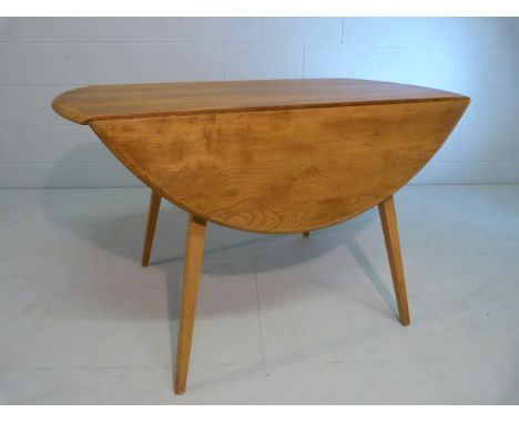 Blonde Ercol drop leaf dining table on stick legs