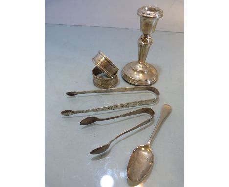 Collection of Silver items to include a two napkin rings, two sugar tongs, a silver filled candle stick & a Georgian spoon 