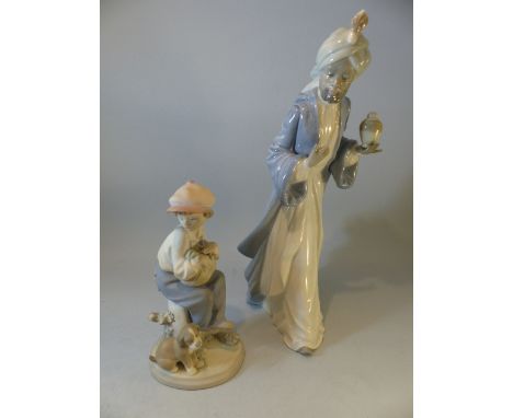 Lladro - figure of a young boy with his puppy No. 5401 along with a tall Nao figure of an Islamic man.