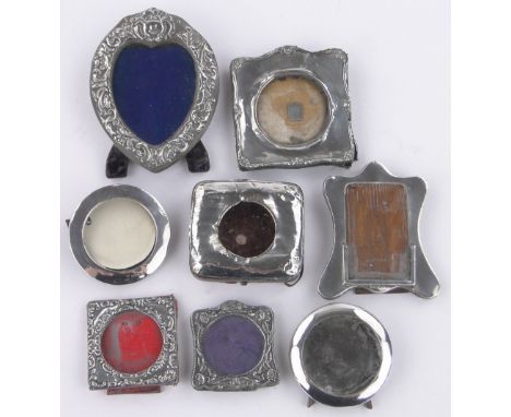 A group of Vintage silver fronted miniature photo frames,and a silver fronted travelling watch case, (8).